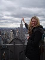 Me pretending to be a giant woman on top of a tall building in New York.